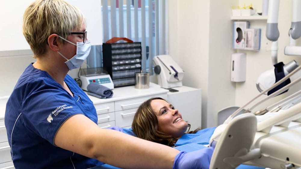 Dental care professional with patient